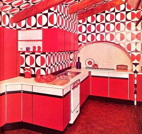 Retro kitchen with red cabinets and bold geometric patterned wallpaper, mid-century modern decor