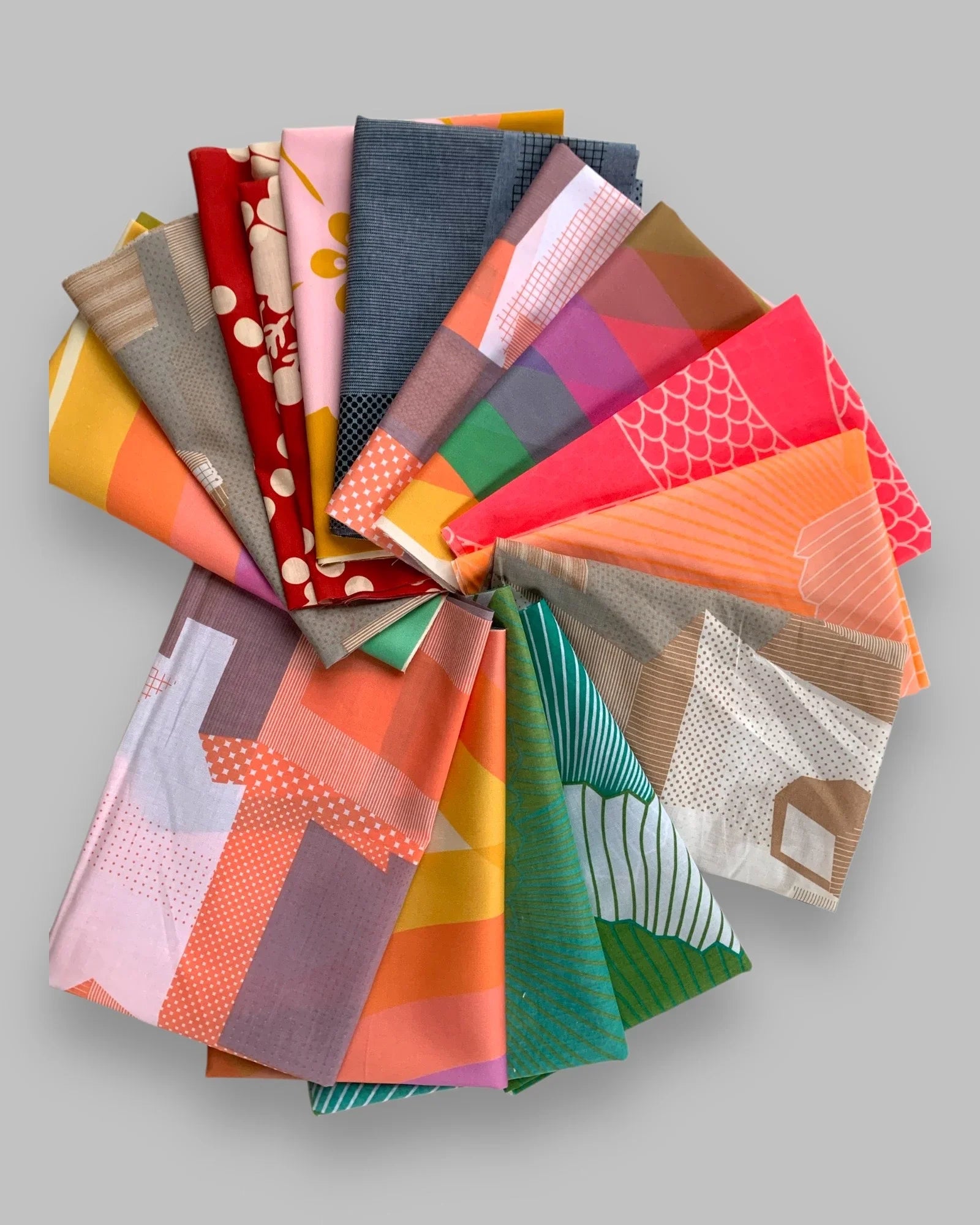 Assorted modern Hawaiian print fat quarter fabrics in vibrant colors, arranged in a circle