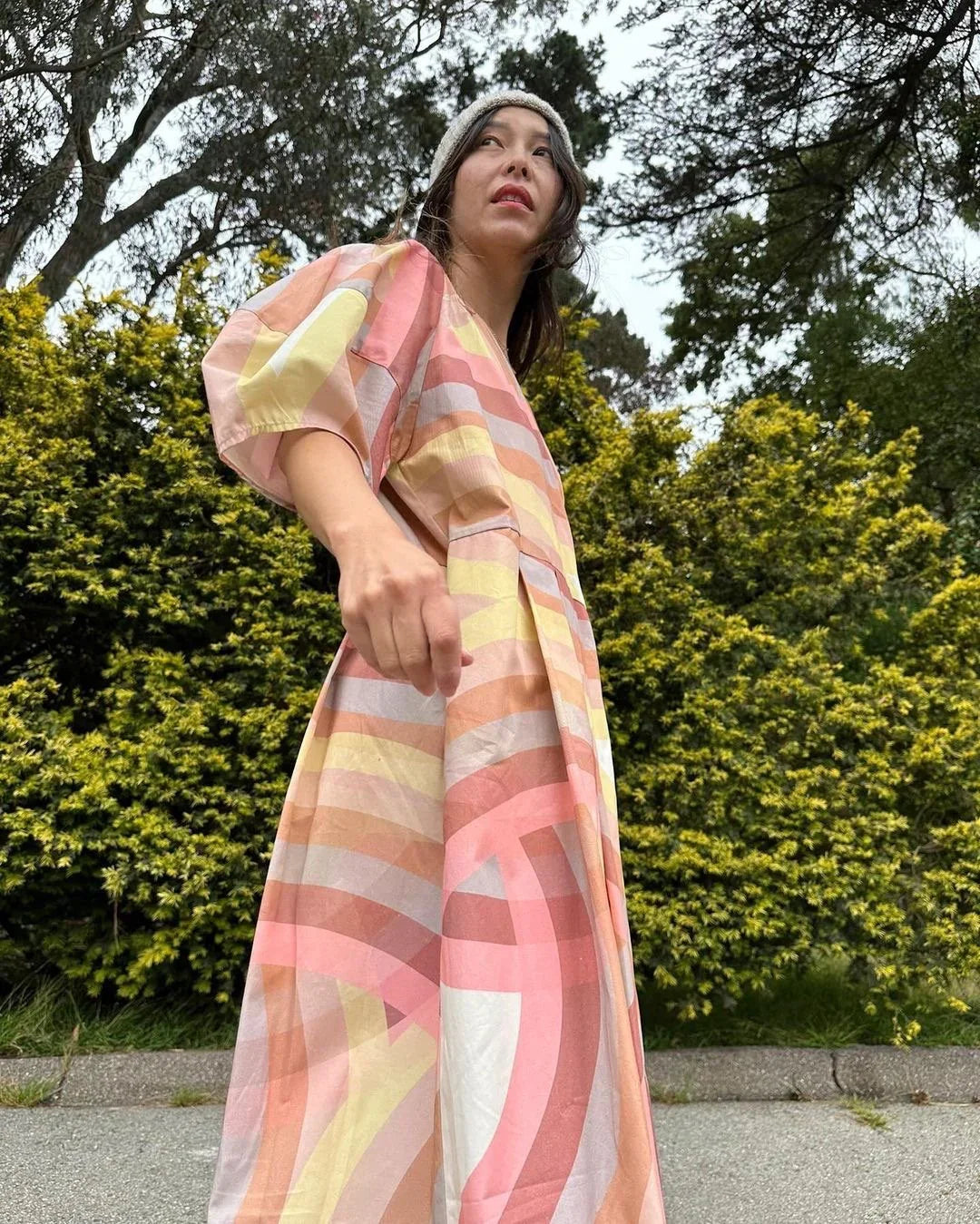 Woman in a colorful modern mu'umu'u dress with geometric print outdoors