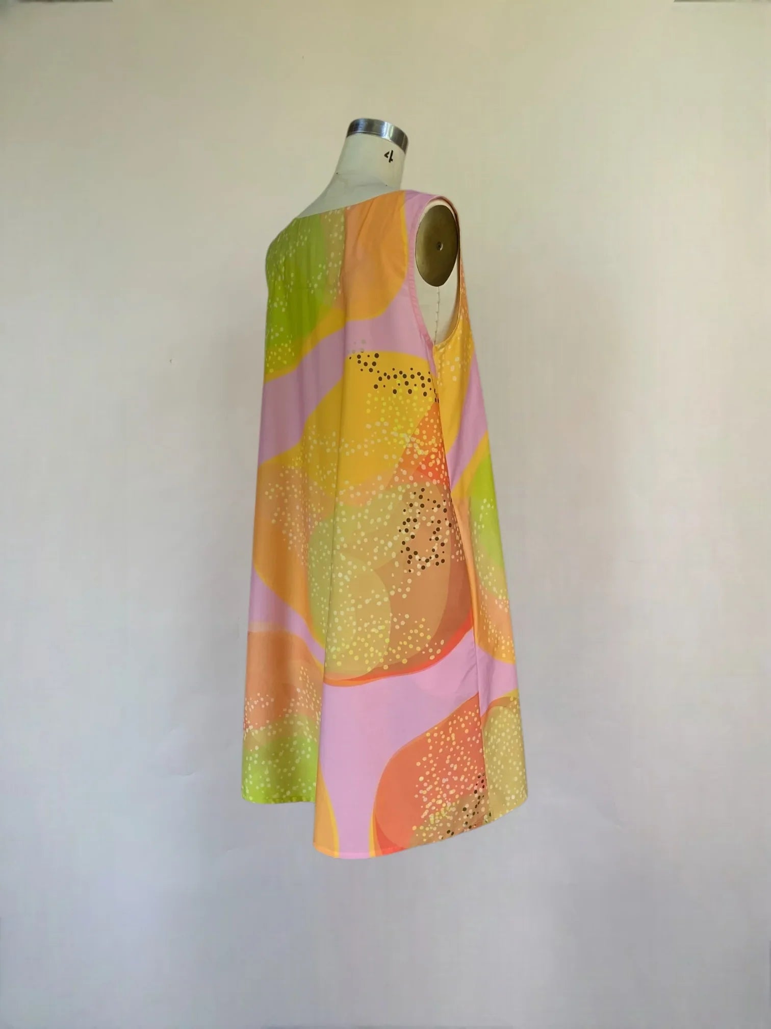A-line sleeveless mu'umu'u dress with pastel Hawaiian print on mannequin