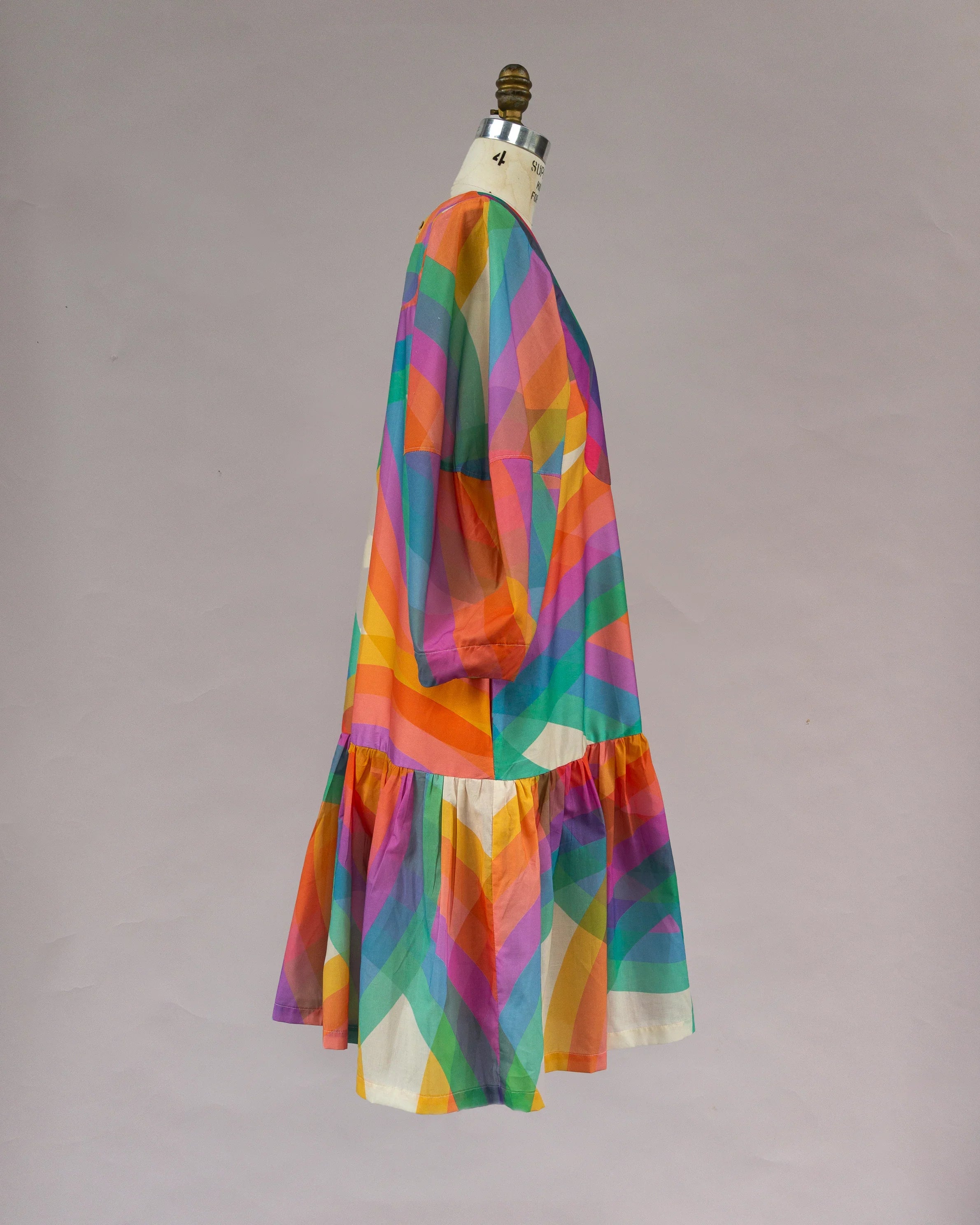 Colorful geometric print muumuu dress with puff sleeves on mannequin
