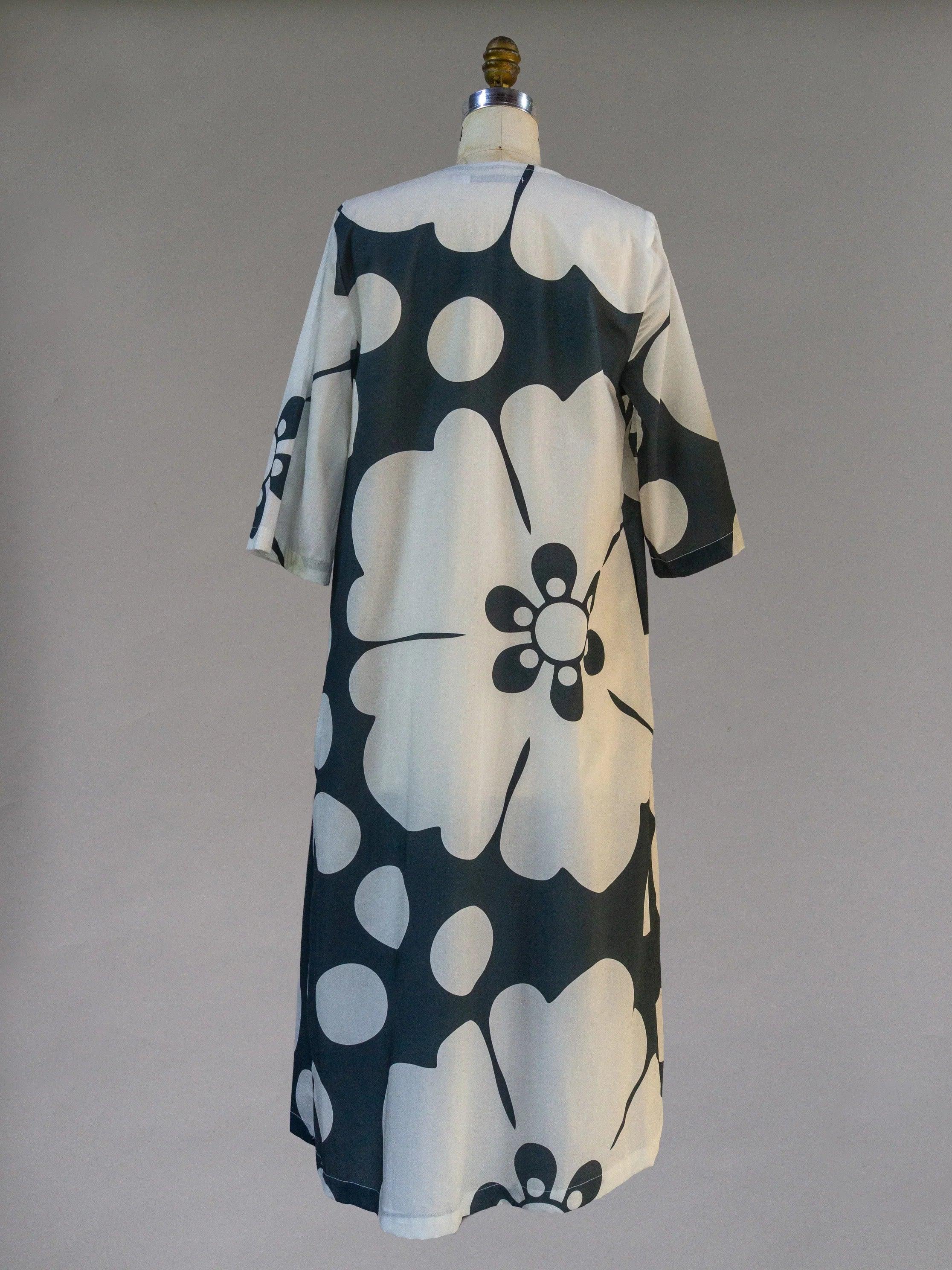 Navy and cream Hawaiian print pareo dress with oversized floral pattern, shown on mannequin