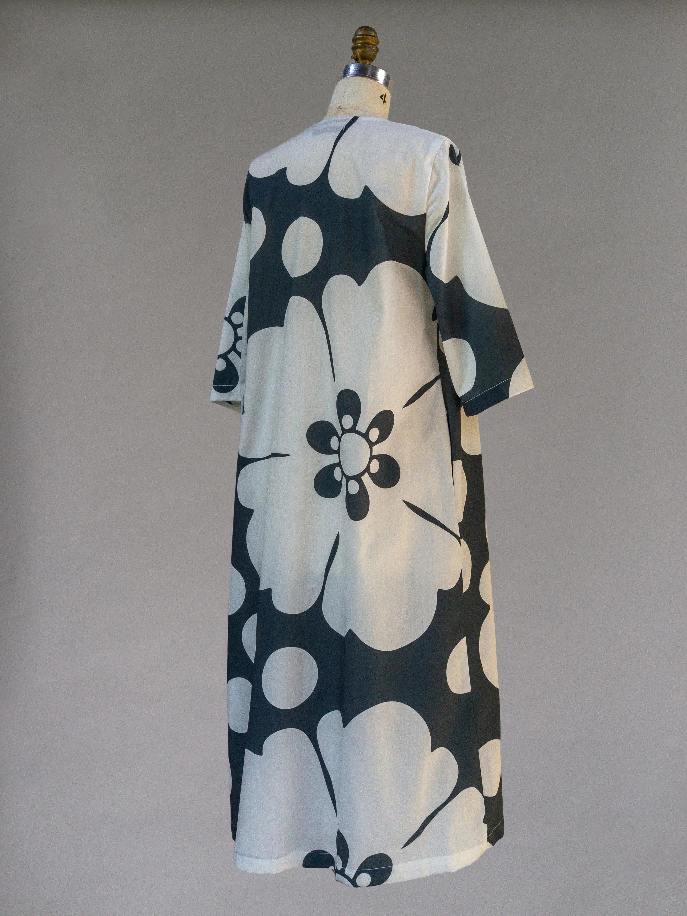 Navy and white Hawaiian pareo dress with large floral print on mannequin