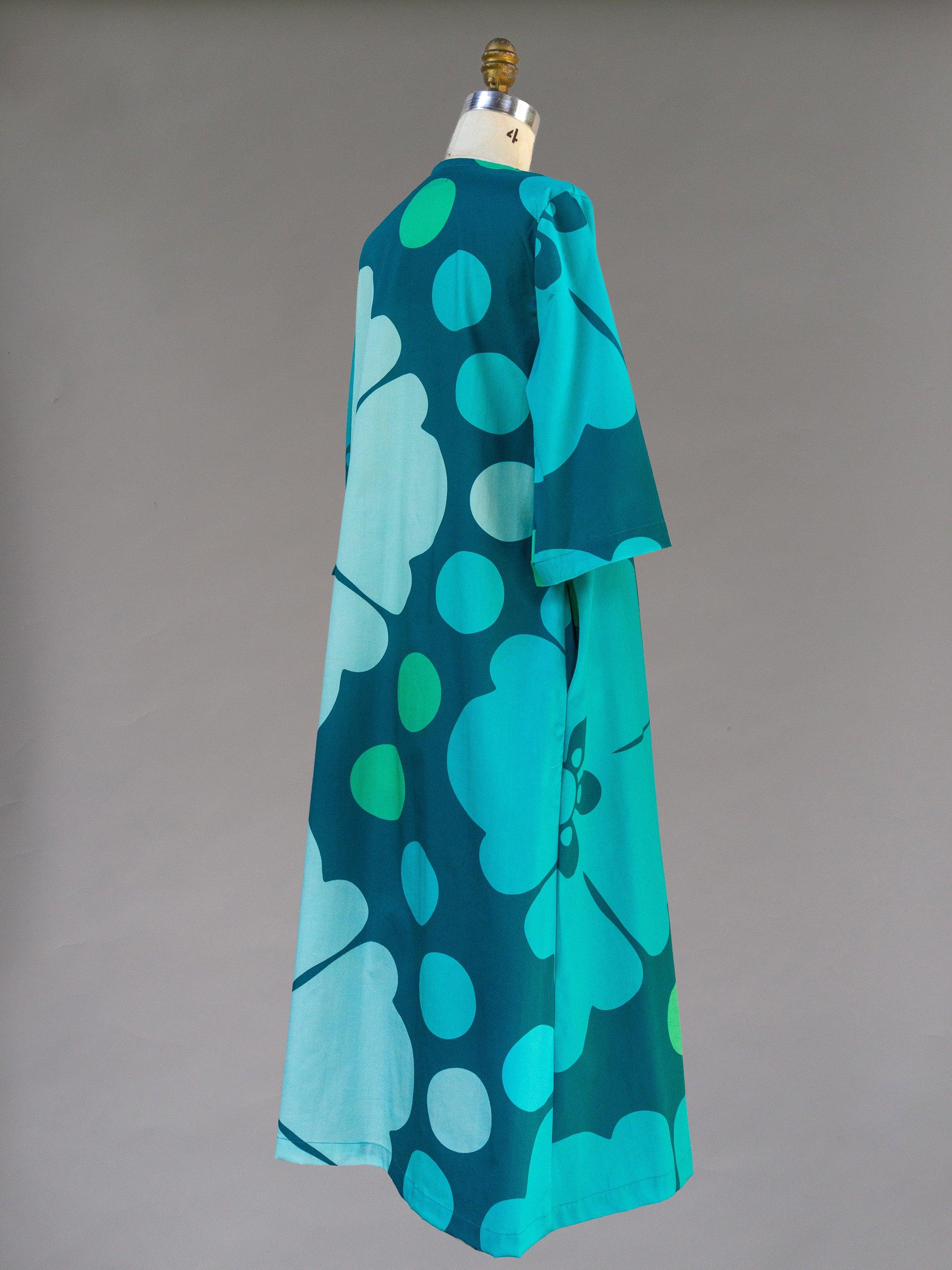 Teal floral pareo dress with ocean-inspired Hawaiian print on mannequin