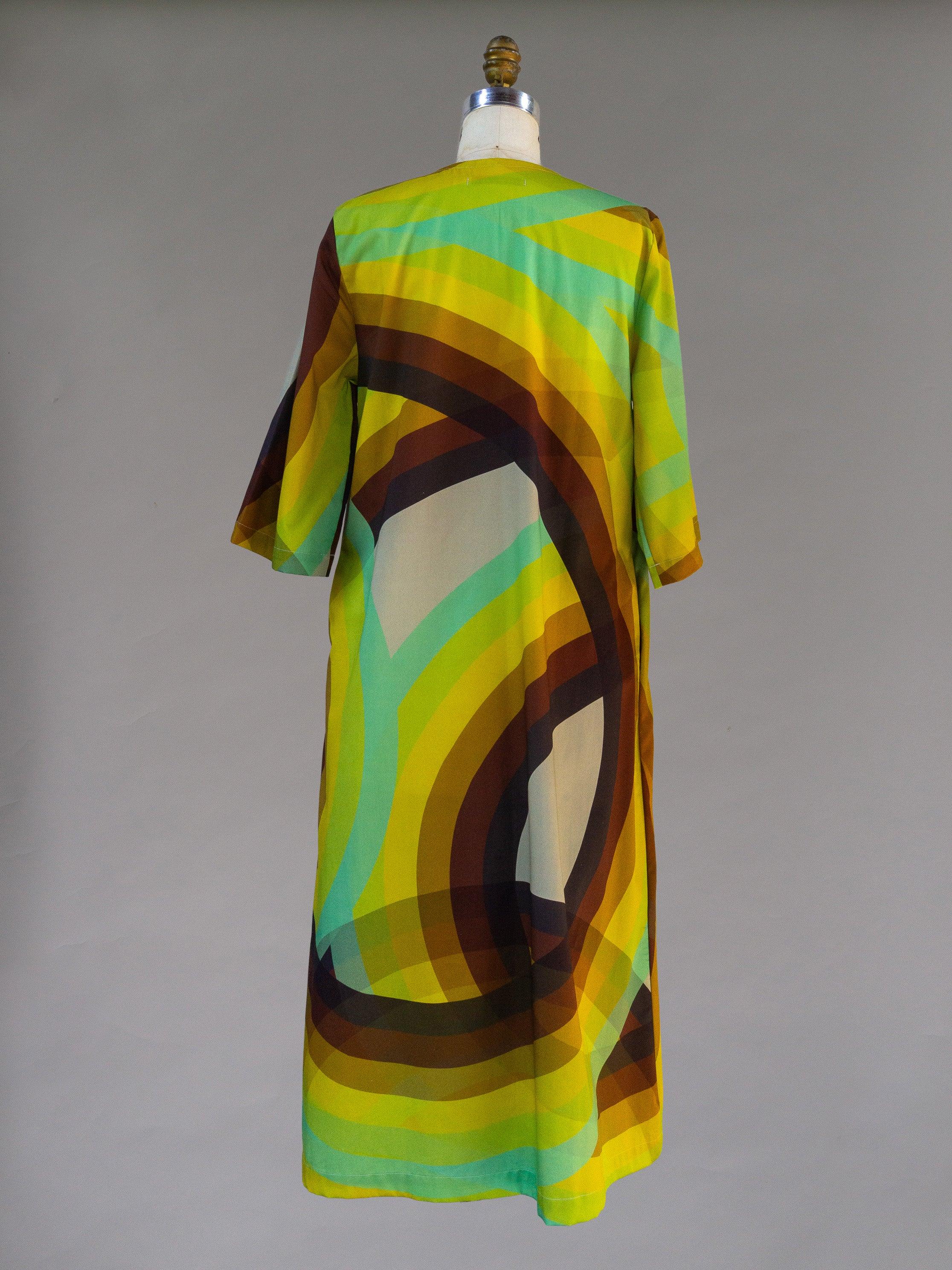 Back view of modern muumuu dress with bold yellow, green, and brown Hawaiian print