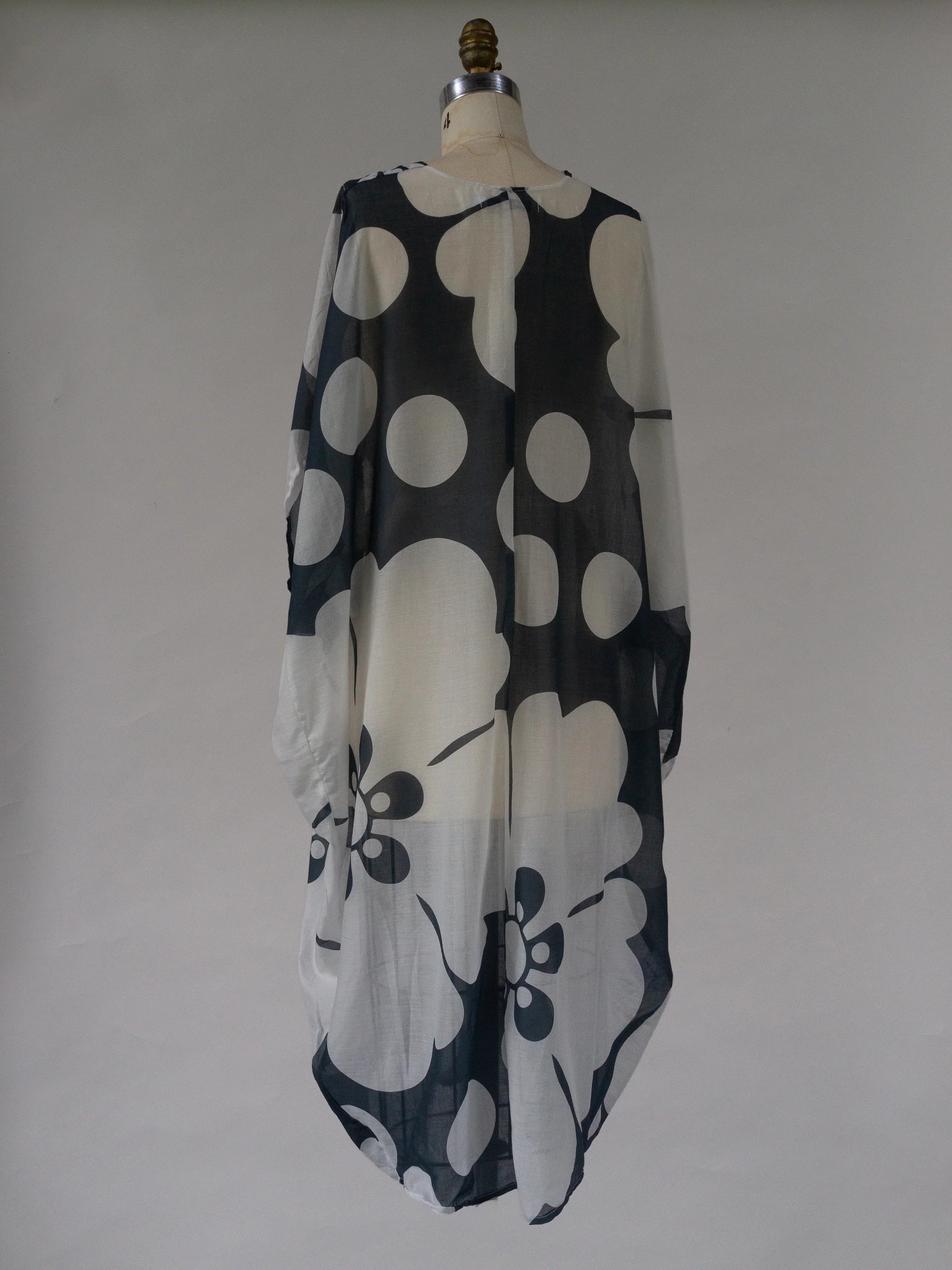 Navy and white floral print kaftan jumbo pareo dress on mannequin, sheer fabric