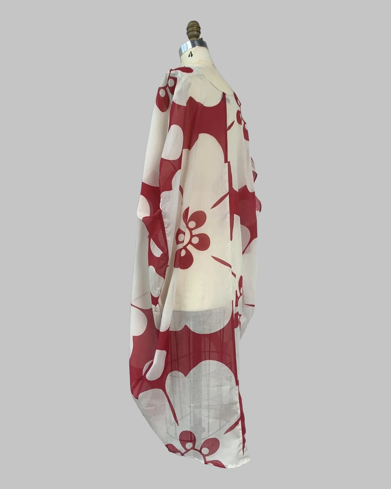 Sheer jumbo red and white floral kaftan pareo dress on mannequin