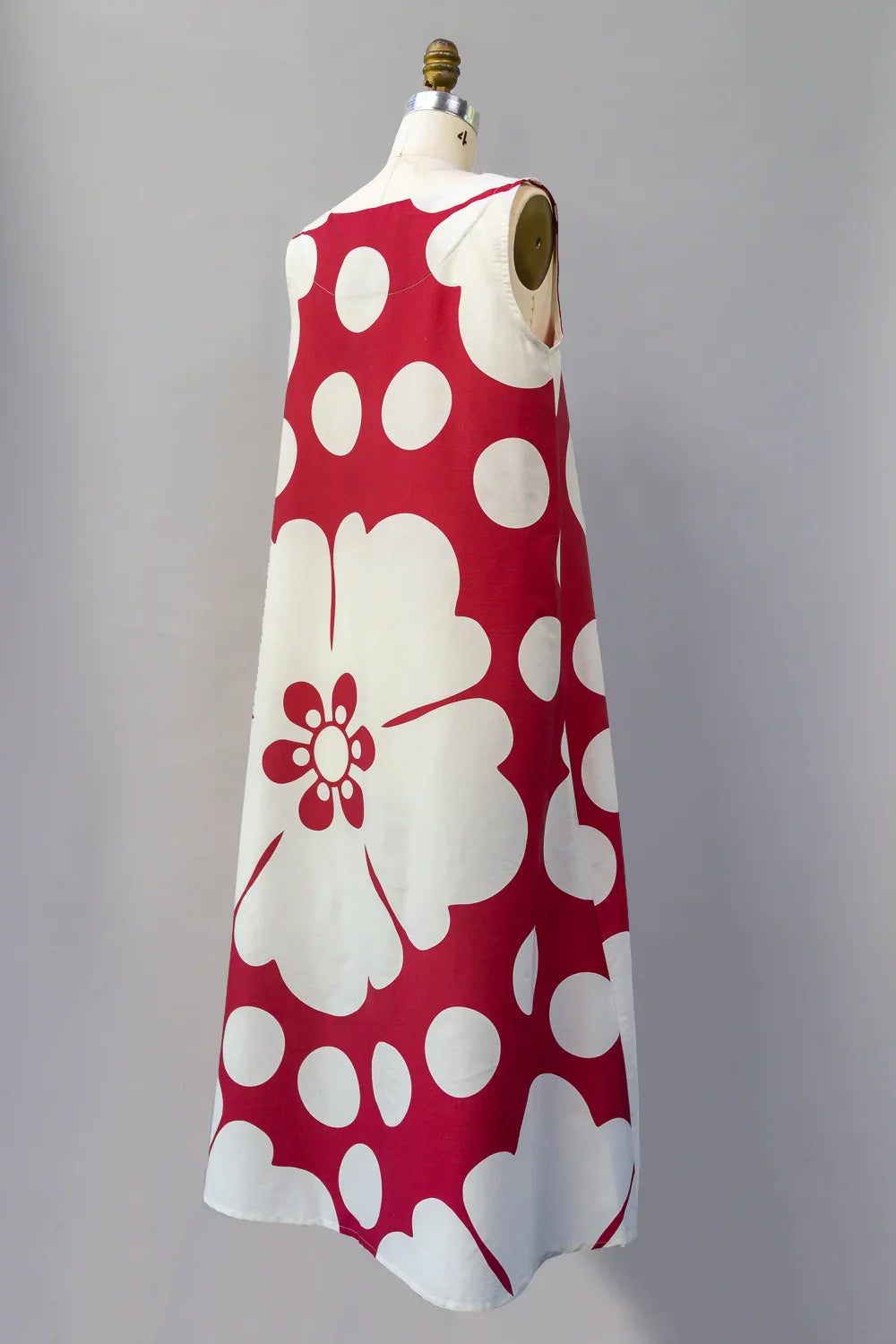 Sleeveless long muumuu dress with bold red and white Hawaiian floral print