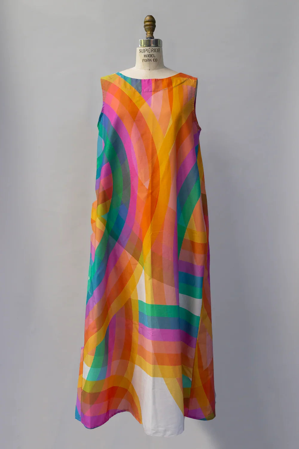 Sleeveless long dress with colorful rainbow geometric print on mannequin