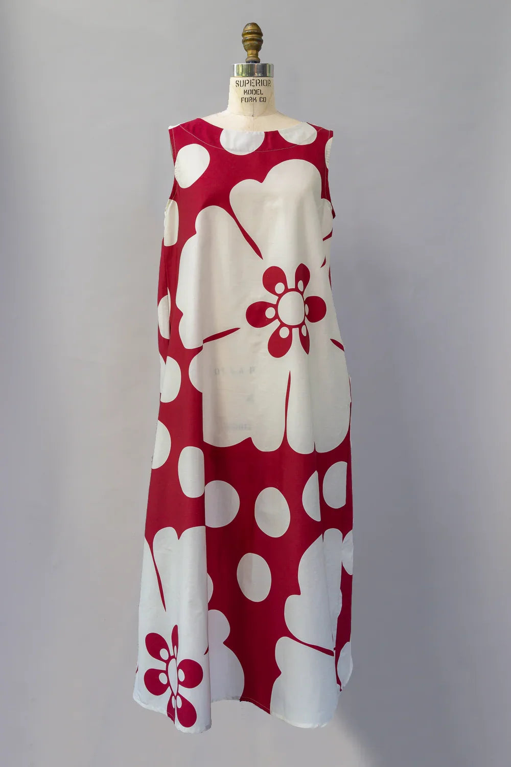Sleeveless long muumuu dress with bold red and white Hawaiian floral print