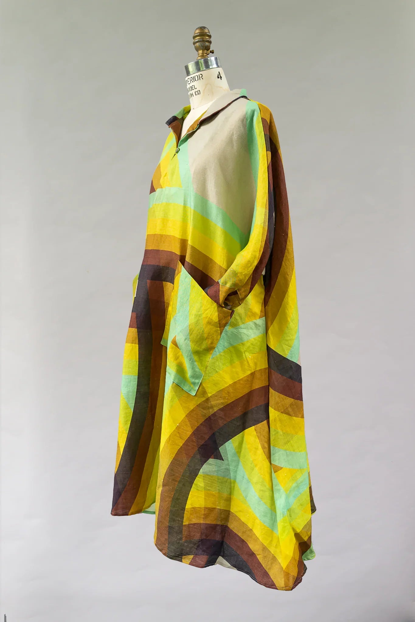Colorful modern mu'umu'u dress with yellow, green, and brown geometric rainbow print