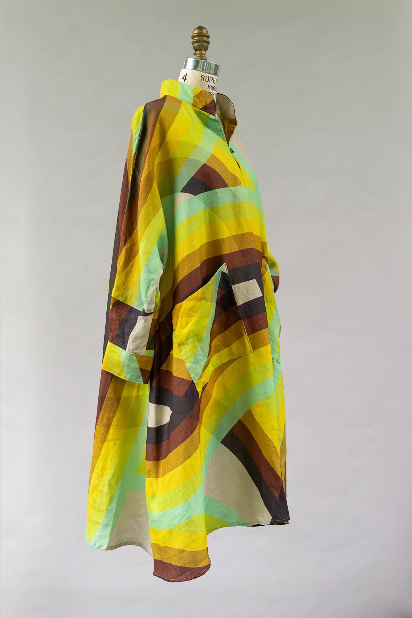 Modern mu'umu'u dress with bold yellow, green, and brown geometric Hawaiian print