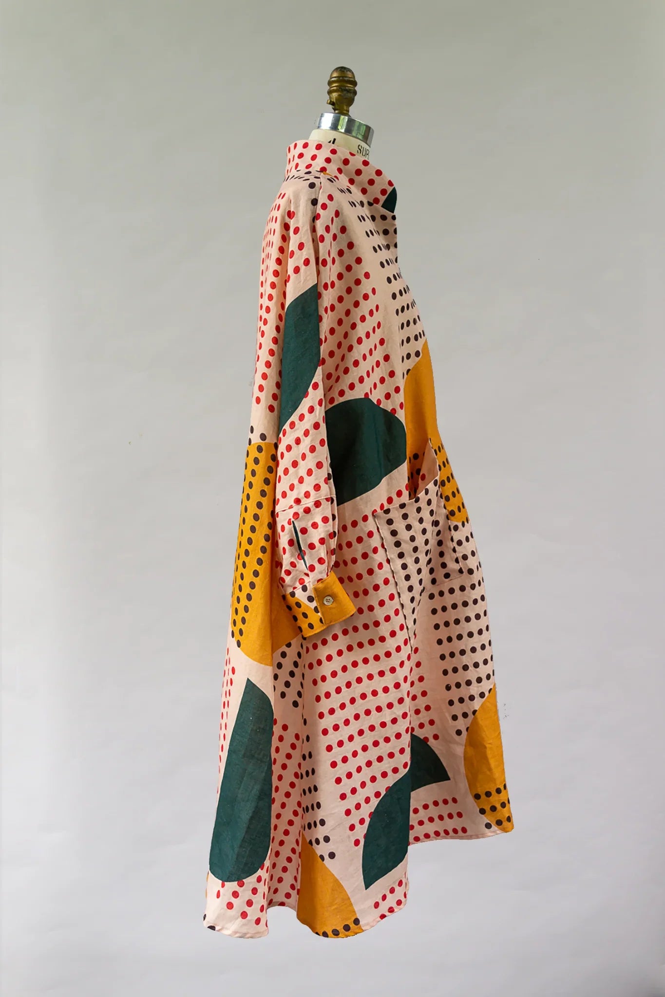 Modern mu'umu'u dress with colorful polka dot and abstract print on mannequin