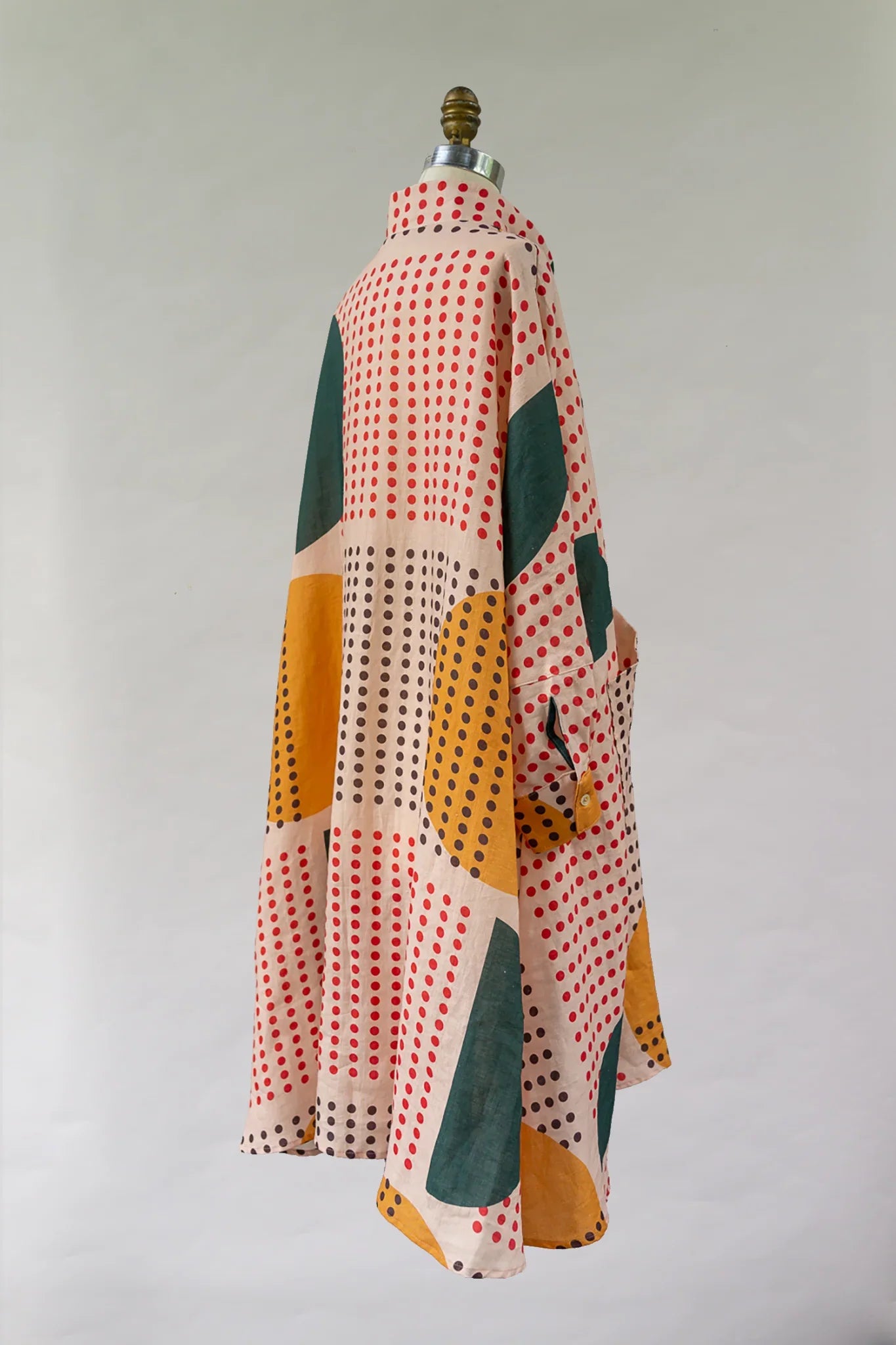 Modern mu'umu'u dress with colorful geometric polka dot Hawaiian print on mannequin