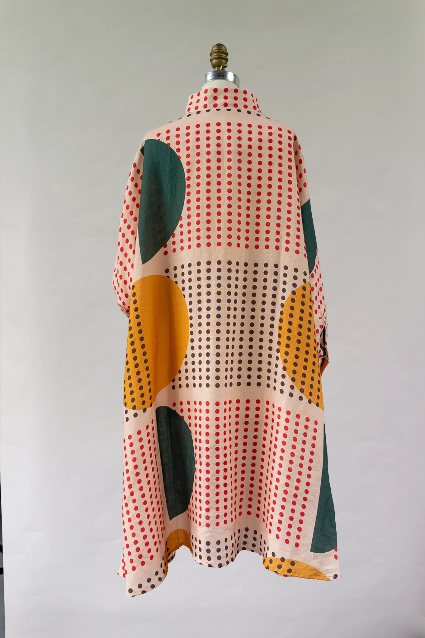 Mu'umu'u dress with retro polka dot and geometric patterns, yellow and green circles