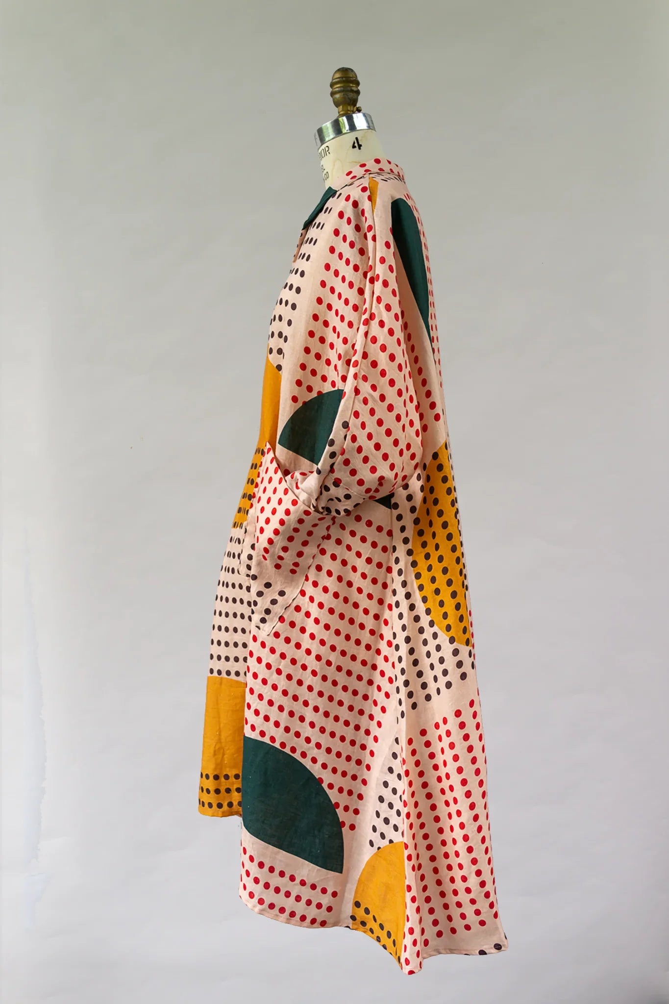 Modern muumuu dress with colorful polka dot and abstract geometric Hawaiian print