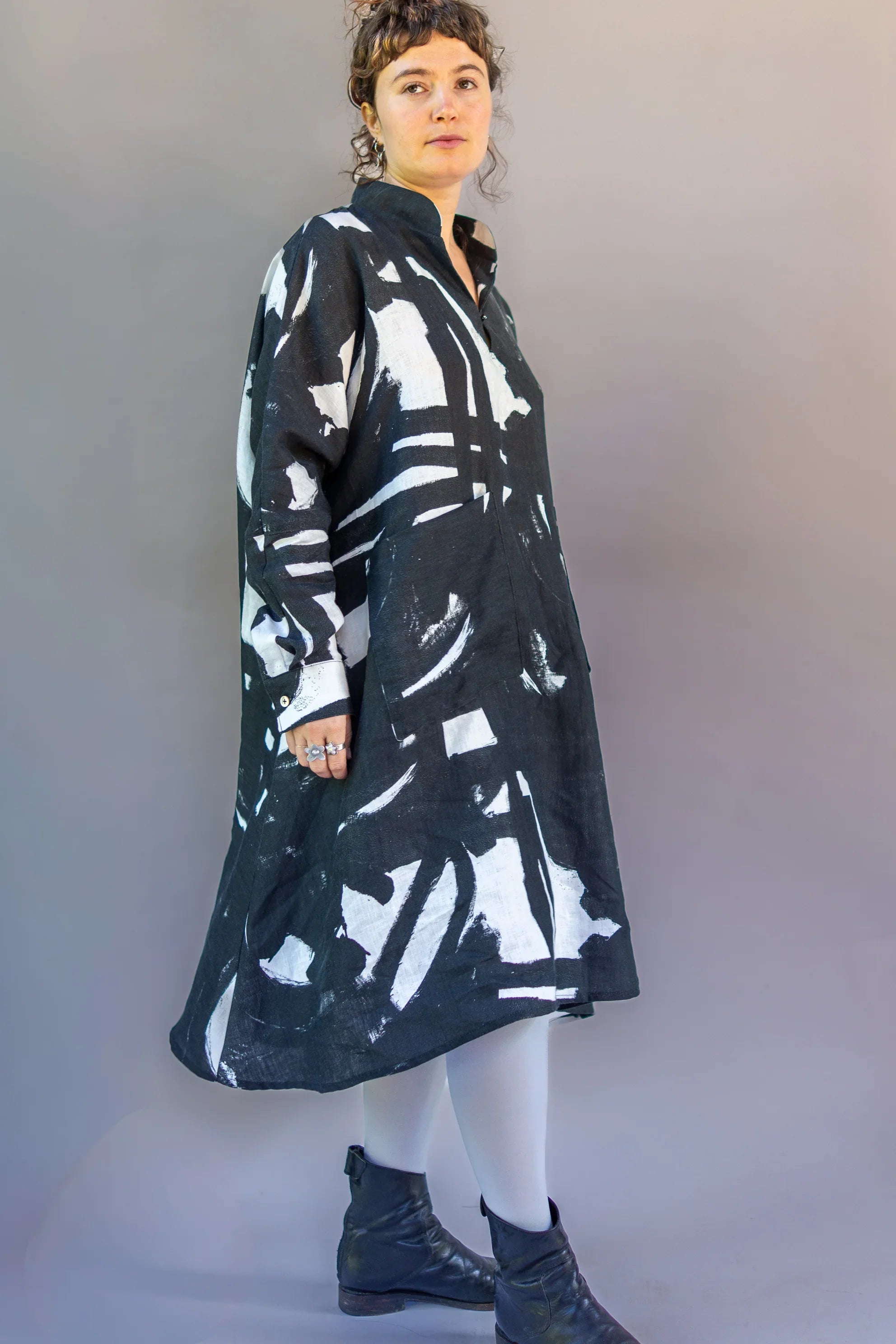 Woman wearing a modern black and white mu'umu'u dress with abstract Hawaiian print