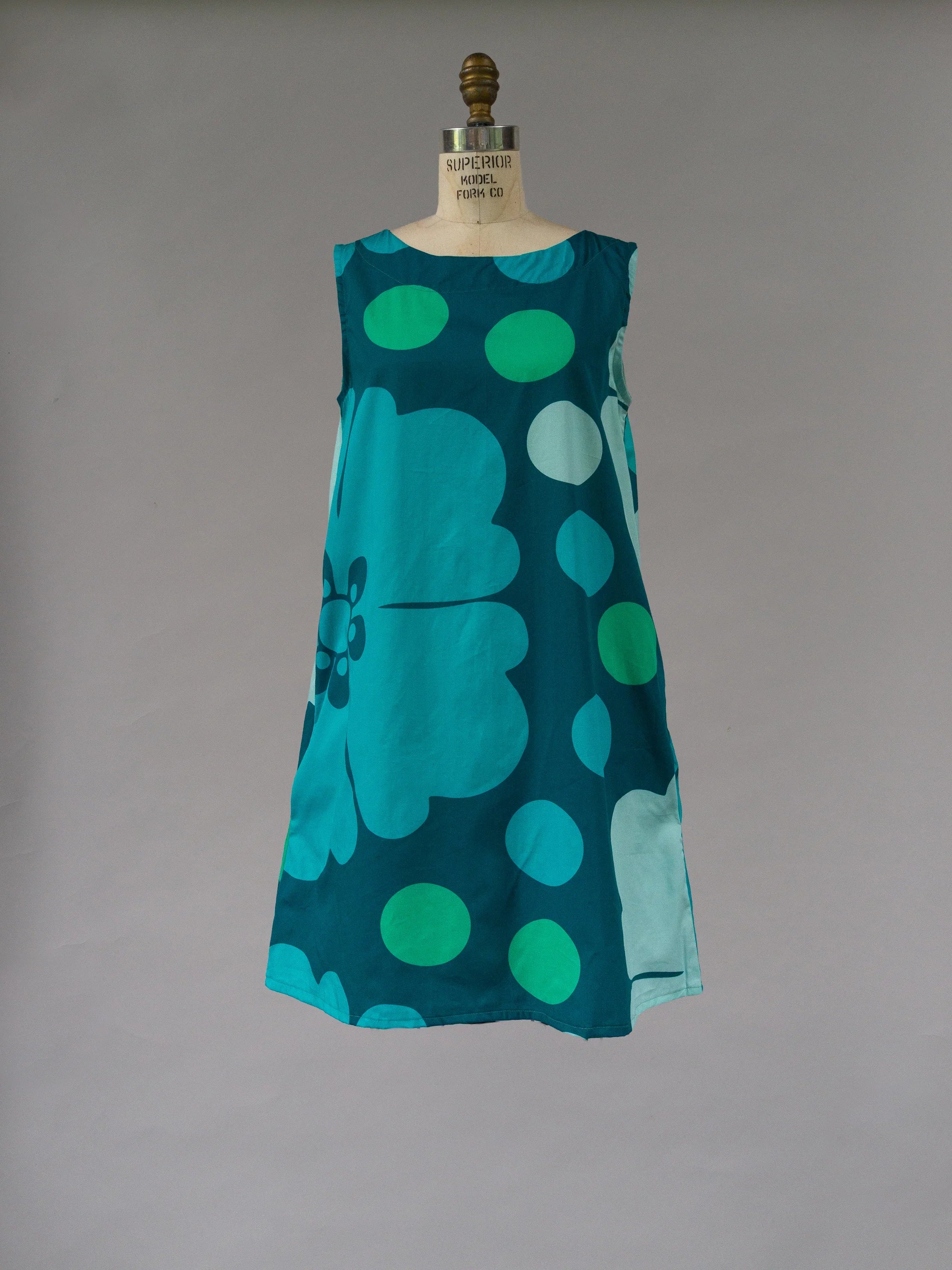 Sleeveless teal muumuu dress with bold ocean-inspired floral and polka dot print