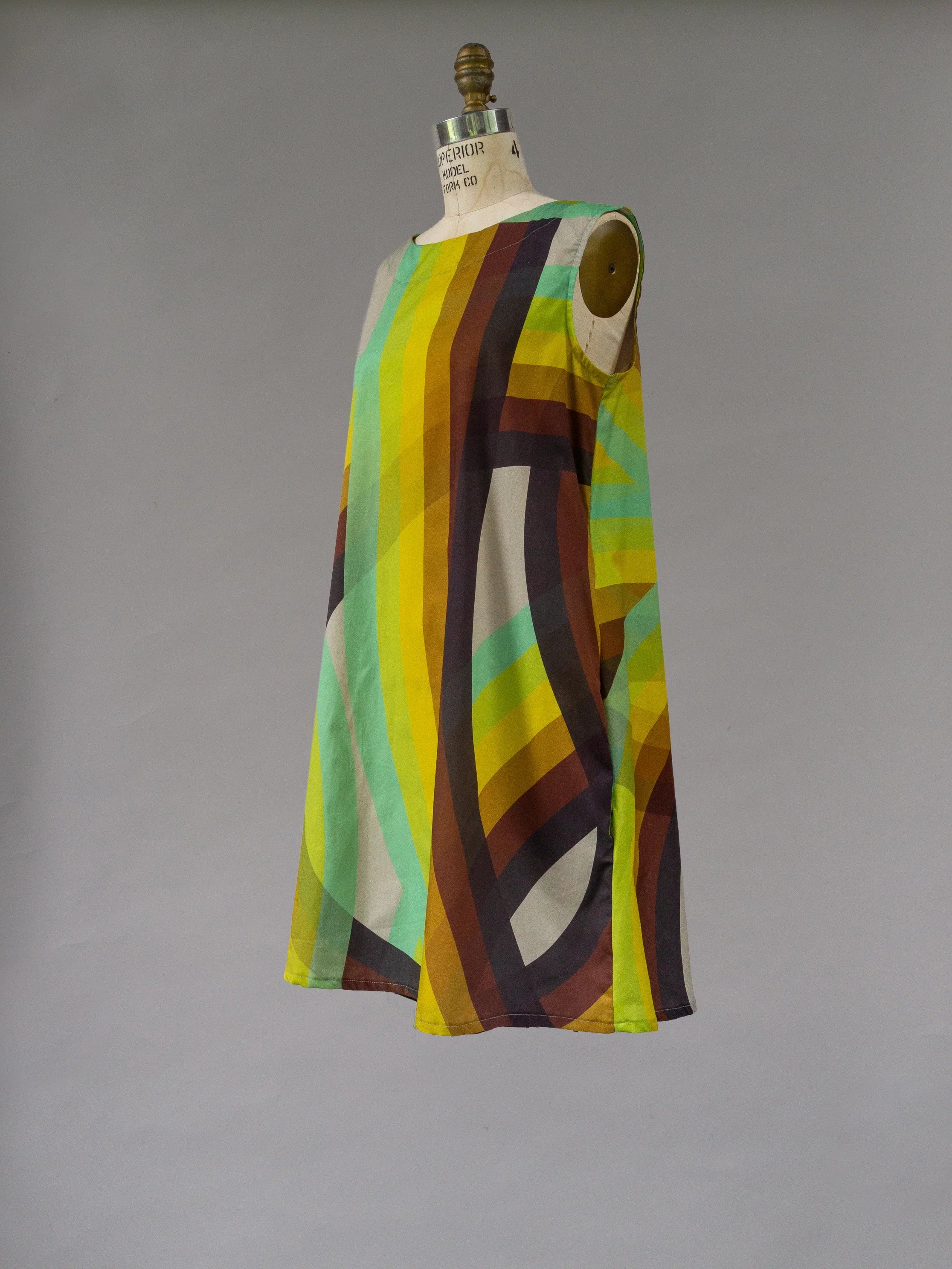 Sleeveless mu'umu'u dress with bold, colorful, geometric Hawaiian-inspired print
