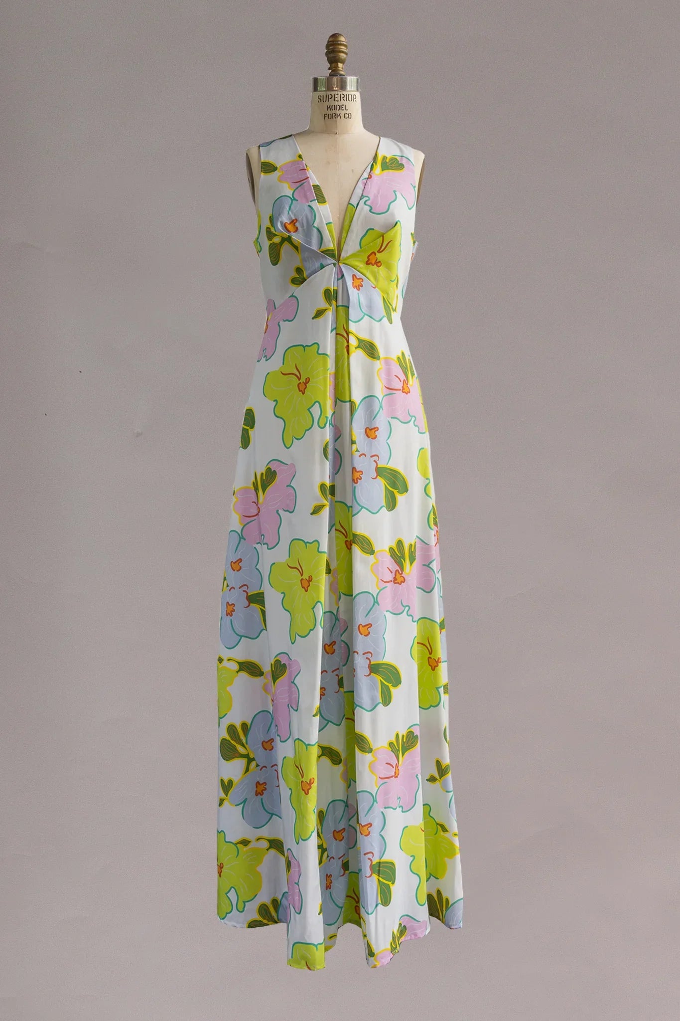 Long sleeveless Hawaiian muumuu dress with vibrant floral print and deep V-neckline