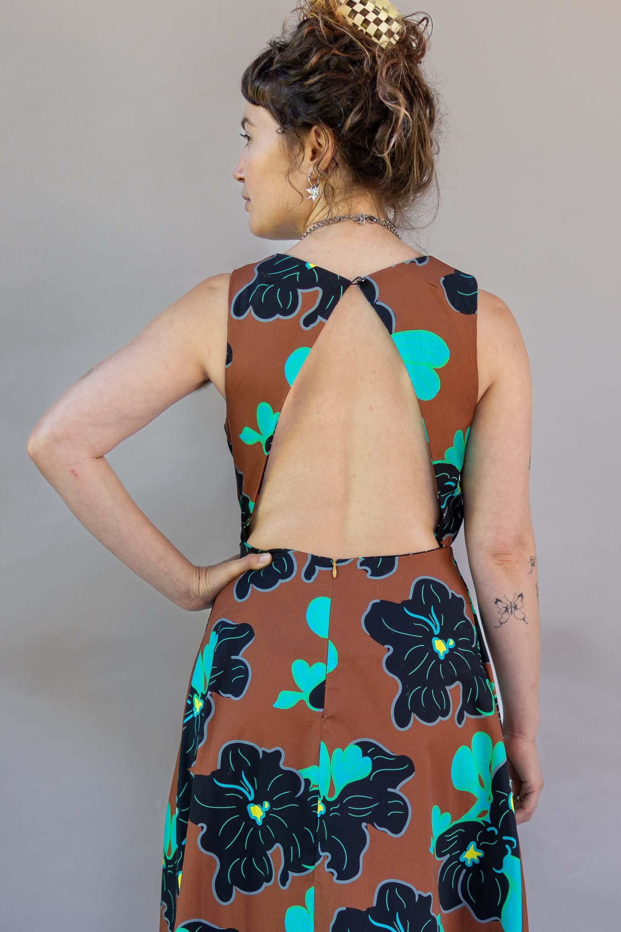 Origami Dress 1961 Chestnut featuring a stylish open back and vibrant floral print.