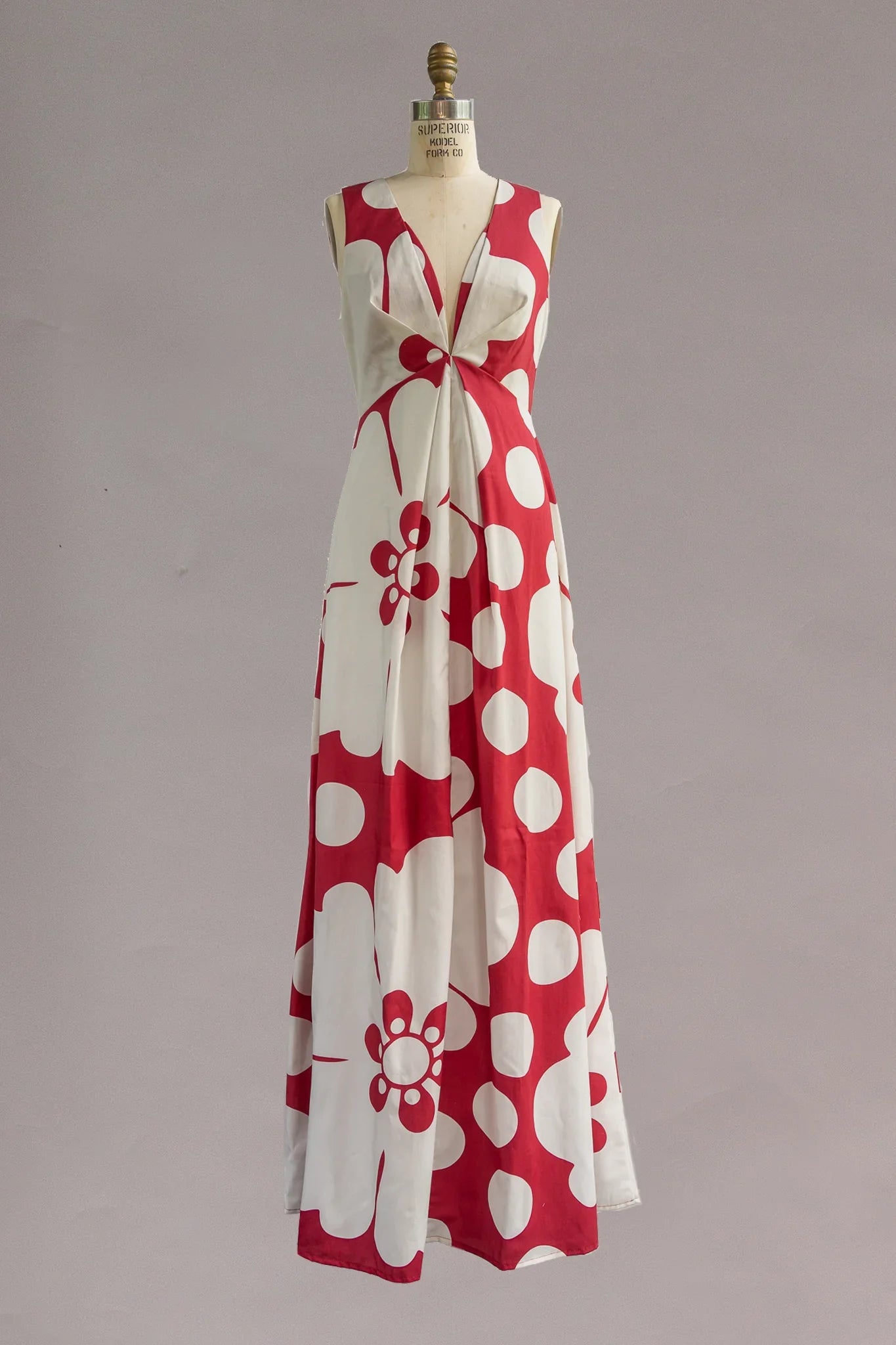 Sleeveless muumuu dress with red and white bold floral and polka dot Hawaiian print