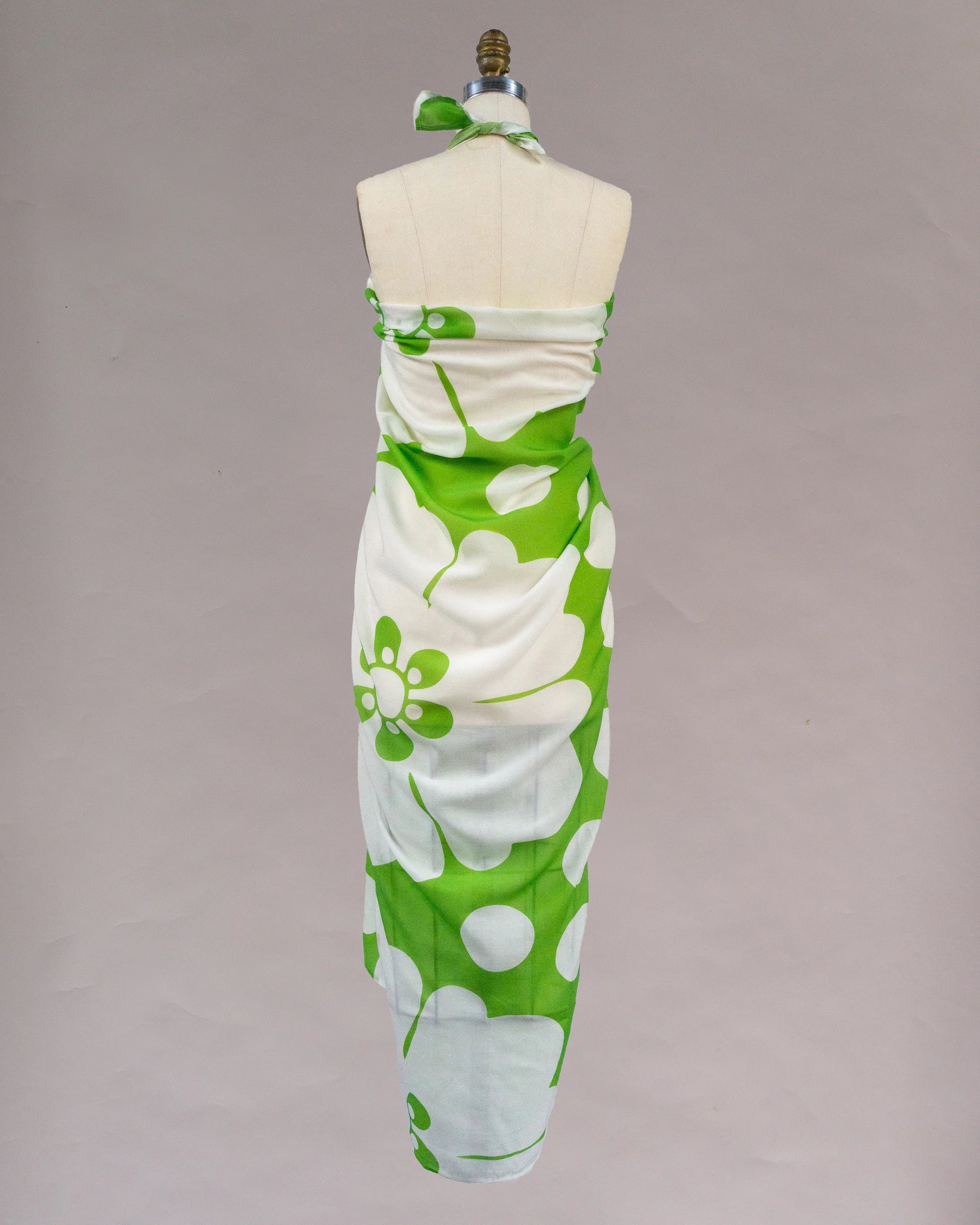 Back view of green and white pareo with large floral print on dress form