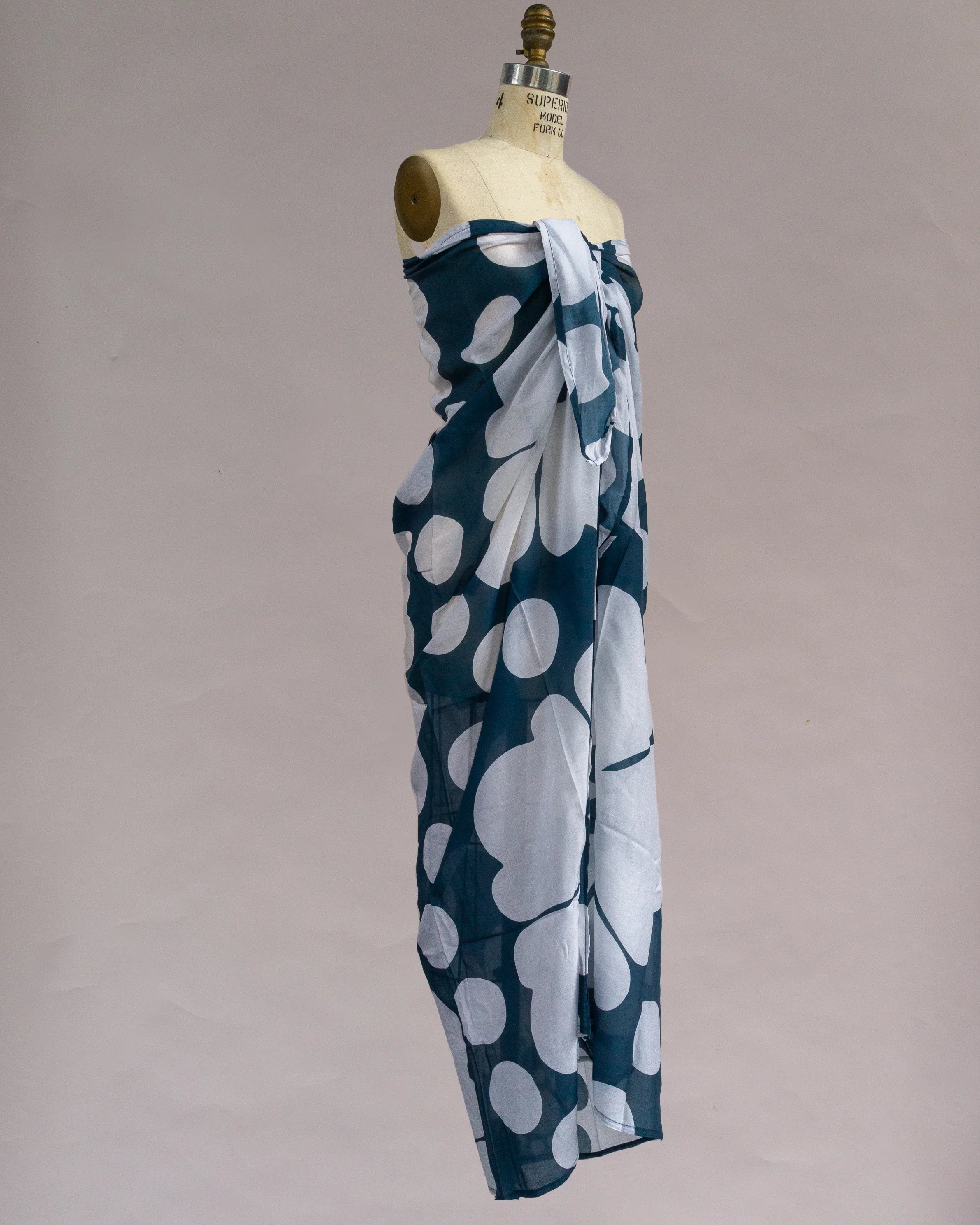 Navy blue pareo with large white abstract floral print on dress form