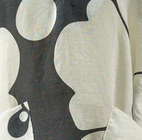 Close-up of navy and ivory Hawaiian print fabric, abstract floral design on pareo material