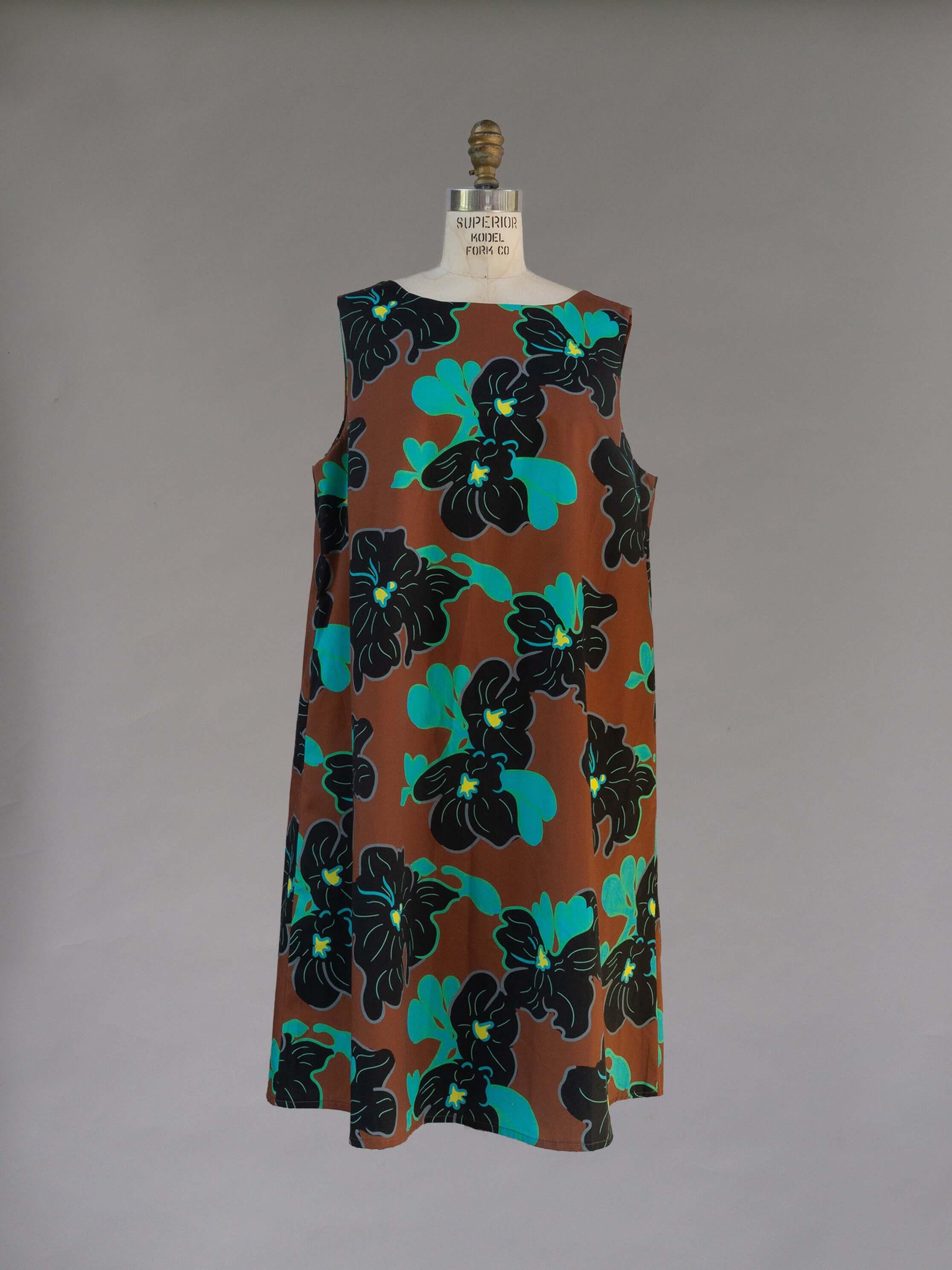 Watteau Dress 1961 Chestnut featuring knee-length style and vibrant floral print with pockets.