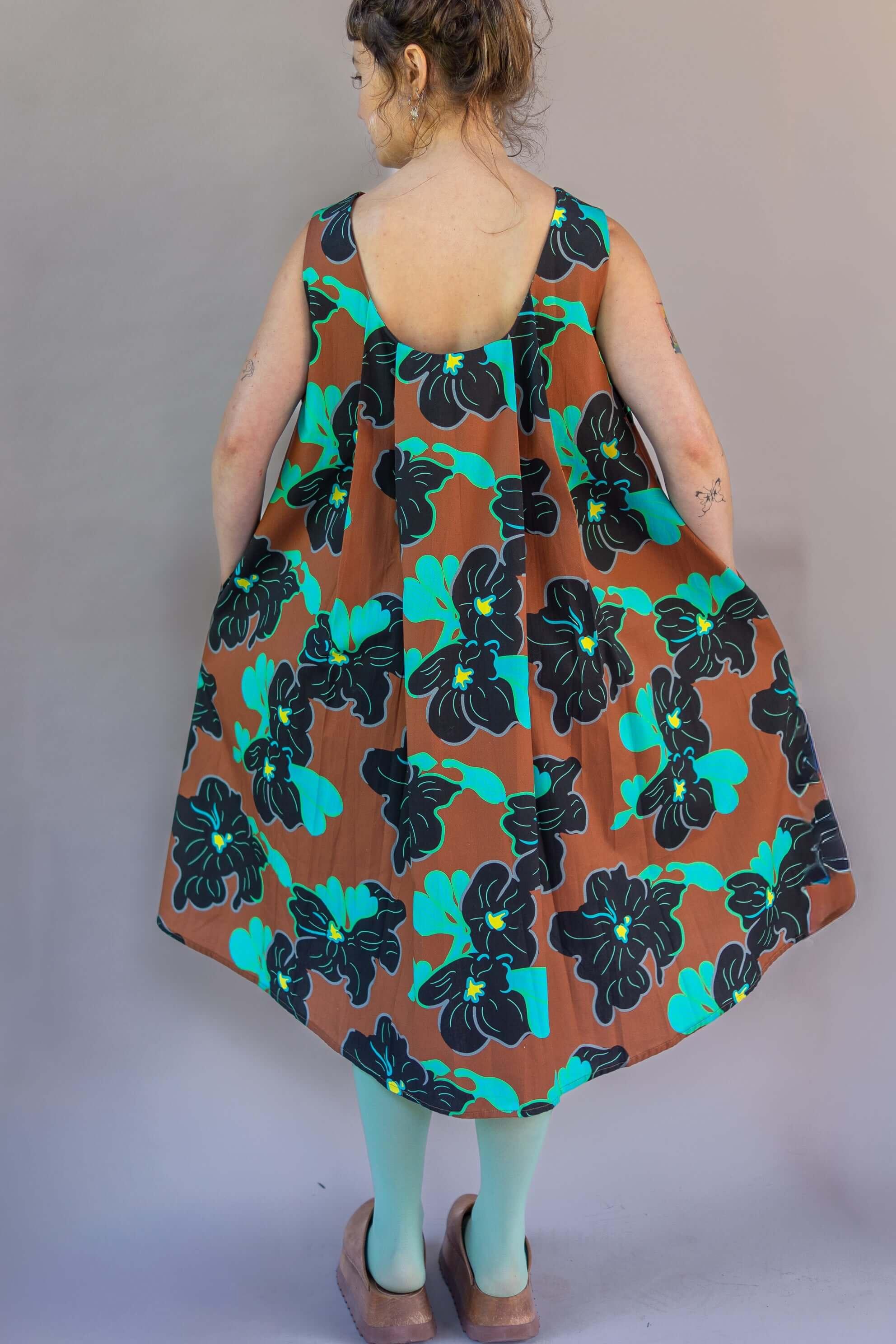 Watteau Dress 1961 Chestnut showcasing modern loose body and iconic pleating, printed in Italy.