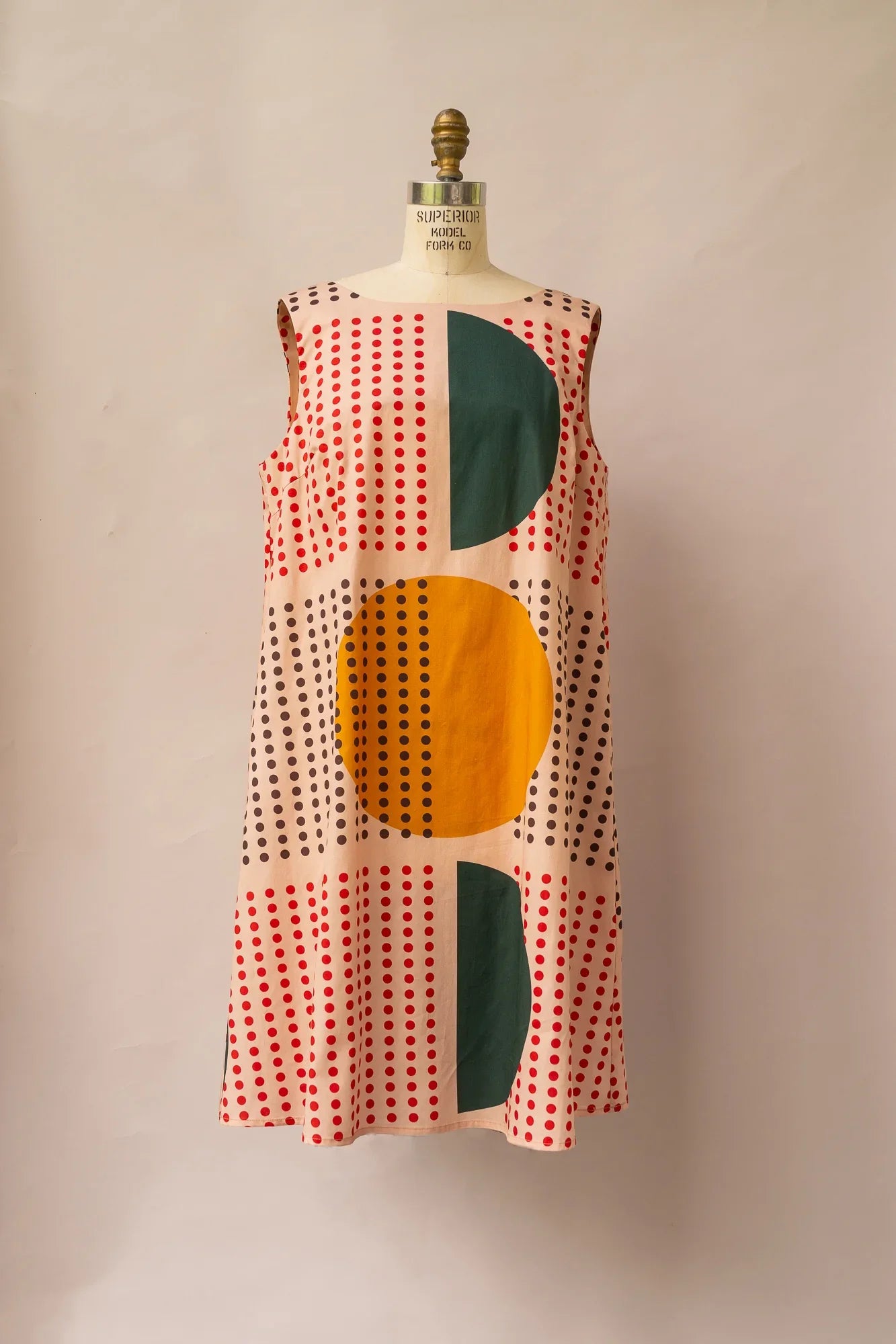 Sleeveless mu'umu'u dress with bold yellow and green abstract shapes and dotted print pattern