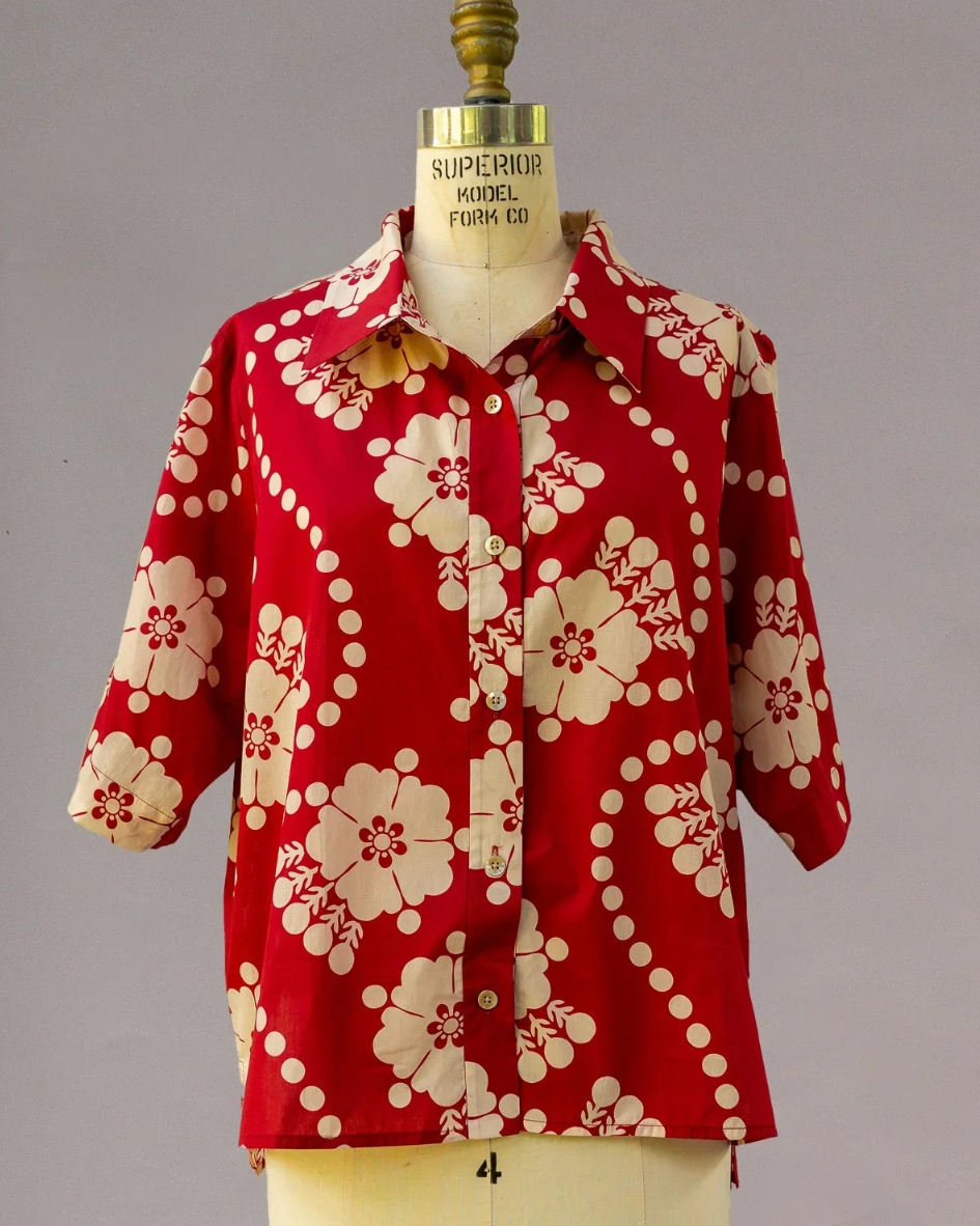 Red Hawaiian aloha shirt with cream floral and dot print on dress form