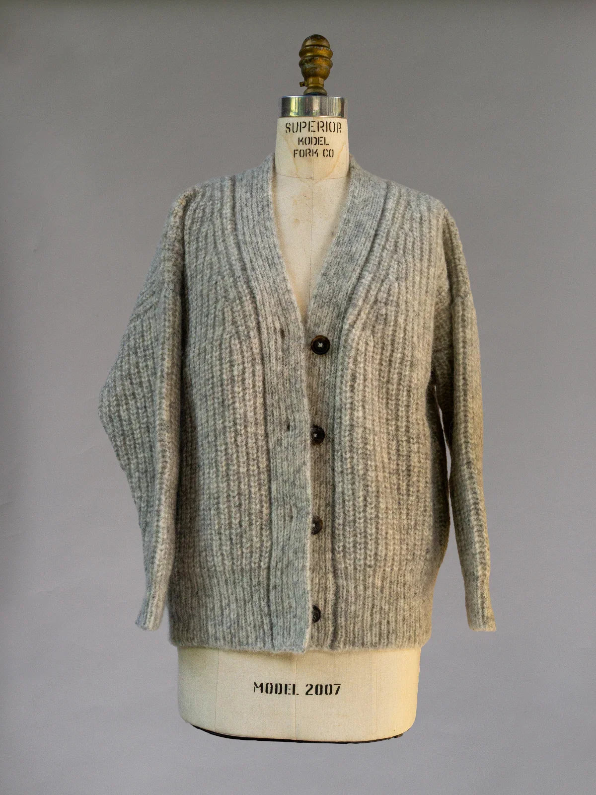 Gray ribbed knit button-up sweater with V-neck, displayed on mannequin